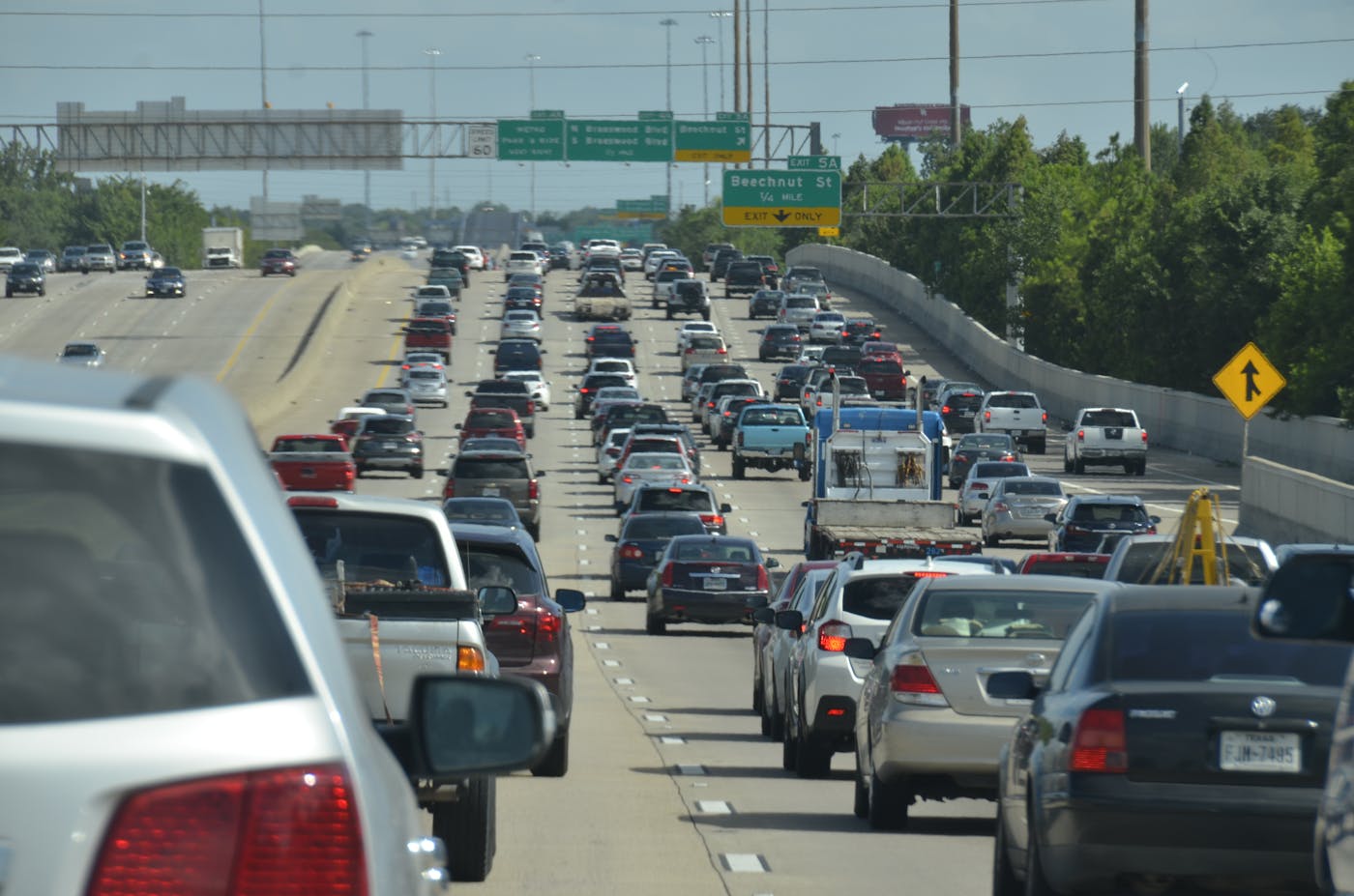 Aerial view of a massive highway interchange packed with traffic despite numerous lanes